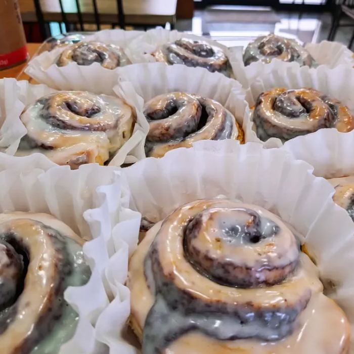 Iced cinnamon rolls in paper cups