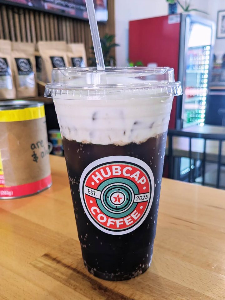 Mags' Special, a Mr. Pibb dirty soda with a tall cap of cheesecake cold foam, in a Hubcap cup with a straw