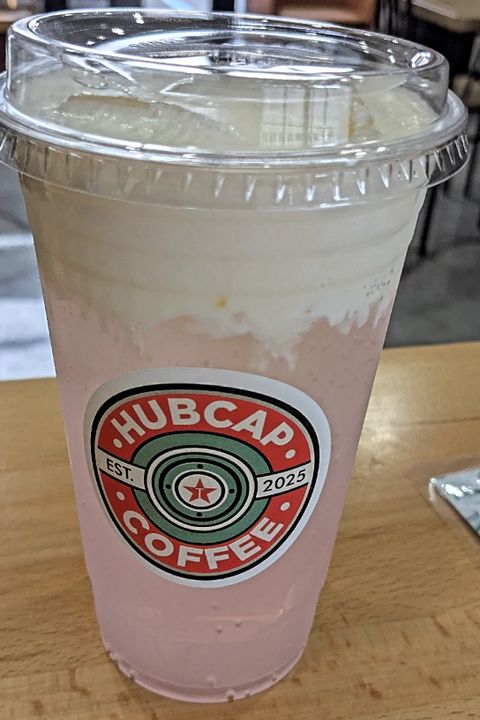 A strawberry smashed lemonade in a Hubcap cup