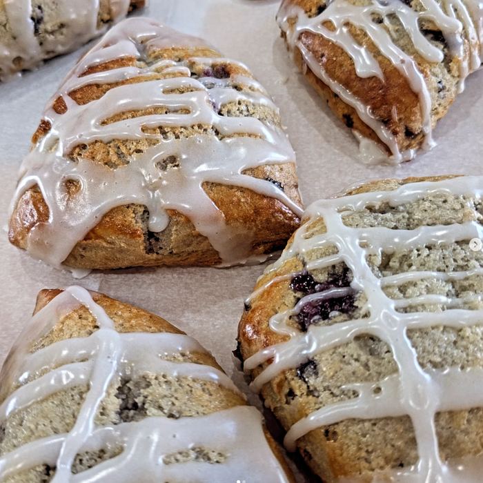 Glazed blueberry scones on parchment